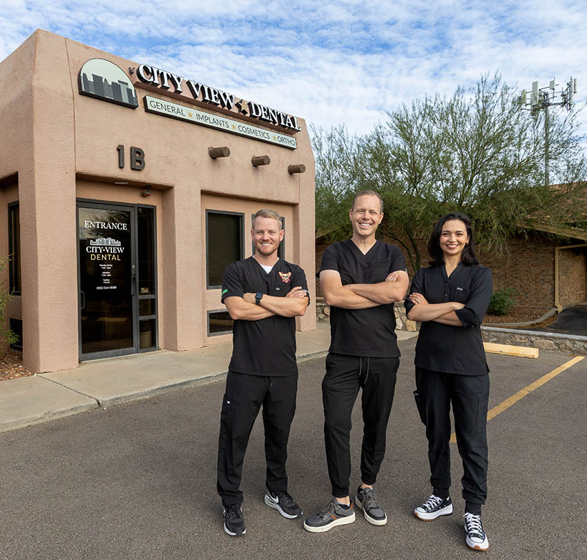 Three dental clinicians outside the City View Dental entrance